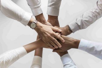 business-hands-joined-together-teamwork-min